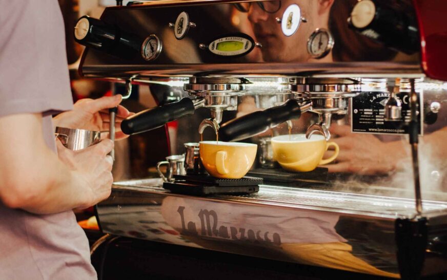 EspressoWorks machine brewing a perfect espresso shot with crema, ensuring optimal temperature control.